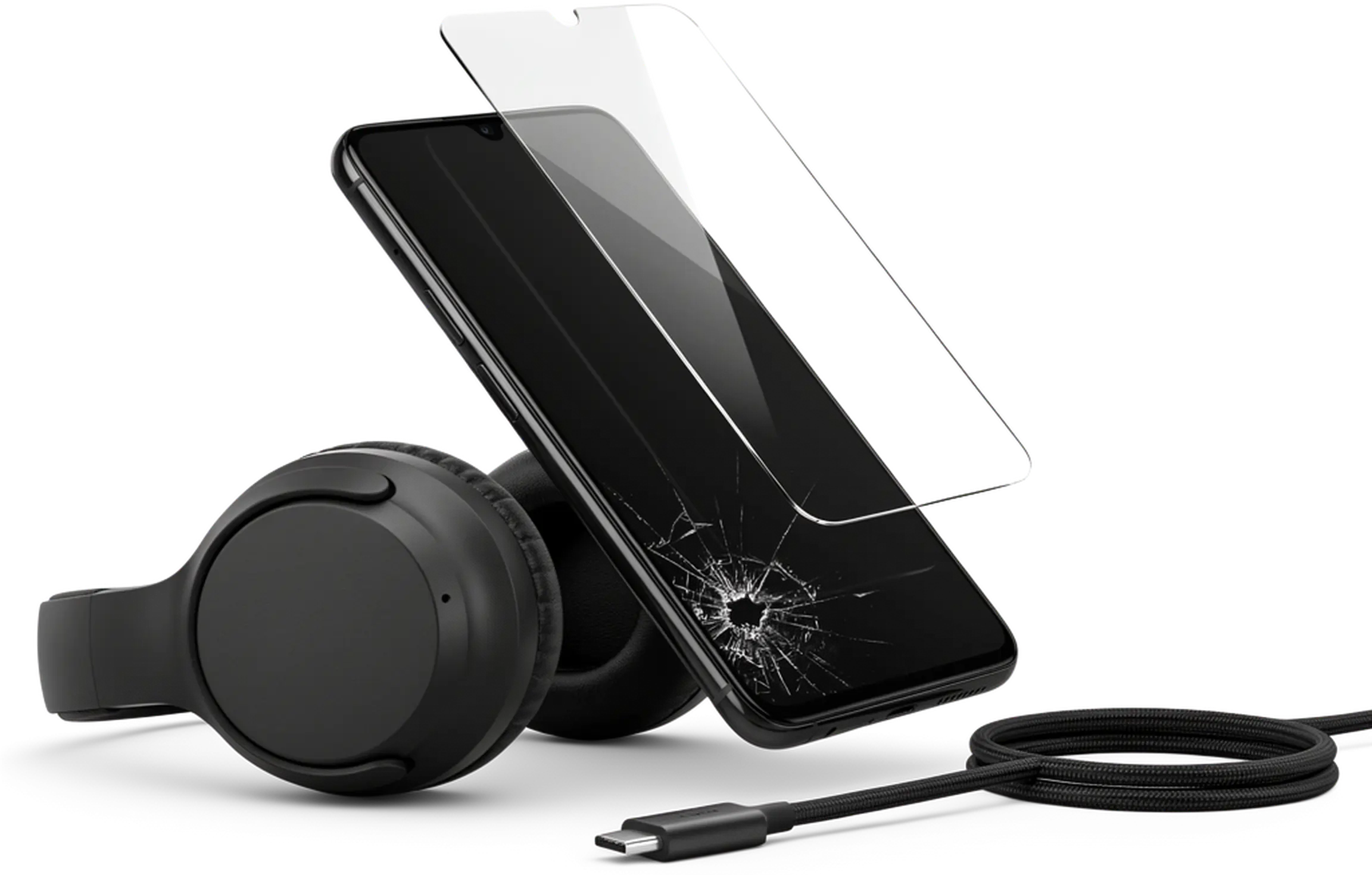 Telefon z pękniętym ekranem, szkło hartowane, słuchawki i kabel USB-C